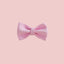 a pink bow tie on a white wall