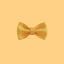 a yellow bow tie on a white wall